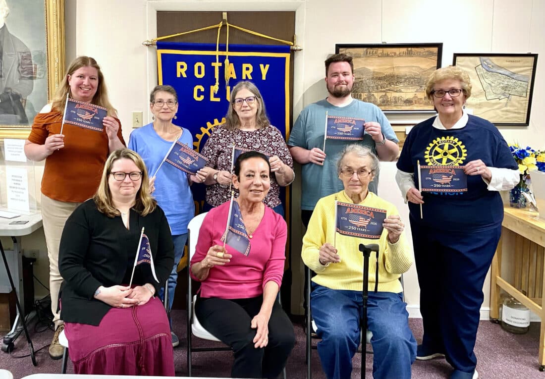 Downtown Rotary members with the 2026 Flags of Honor display in Triangle Park