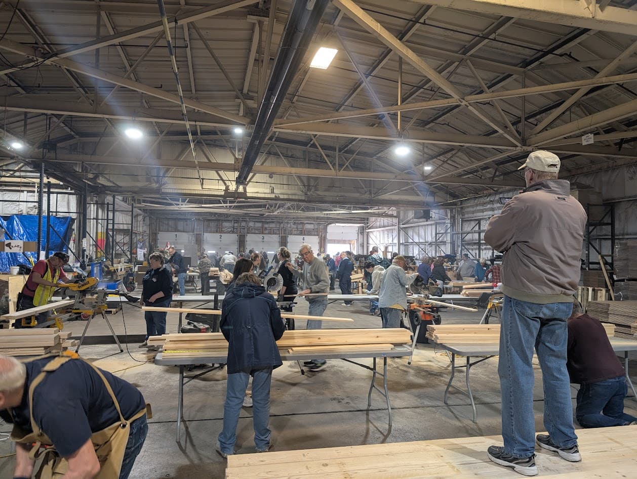 Volunteers cutting and sorting lumber during a Sleep in Heavenly Peace bed build