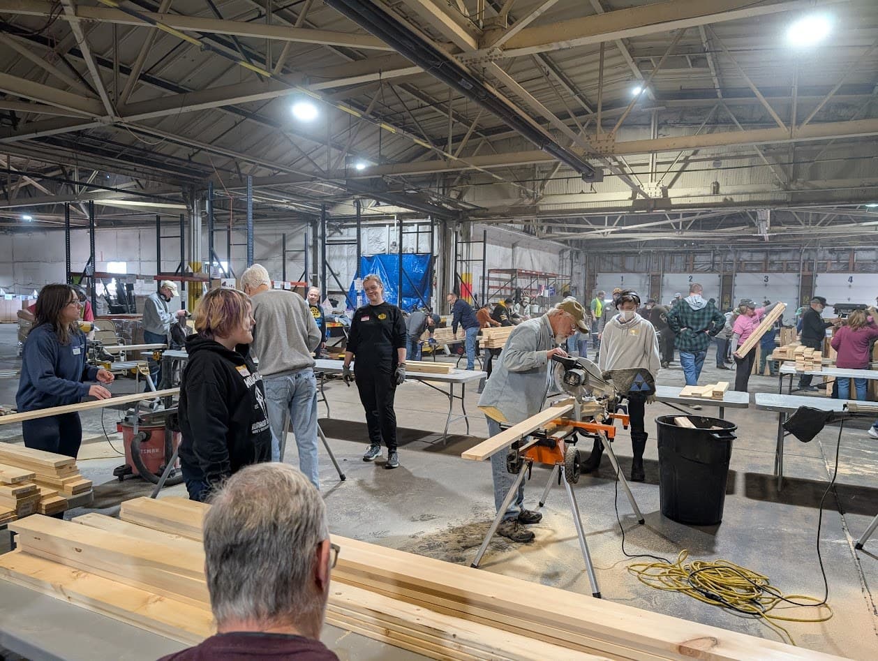 A large group of volunteers at a community bed build