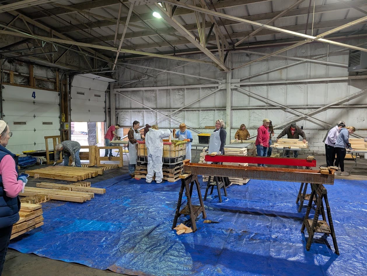 Volunteers staining and finishing bed rails